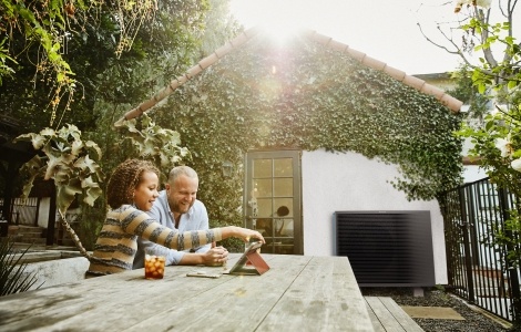 family outside by heat pump