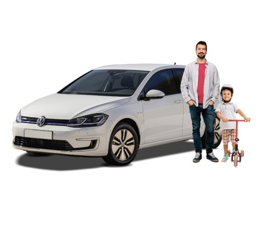 A man and his child stood next to their VW electric vehicle