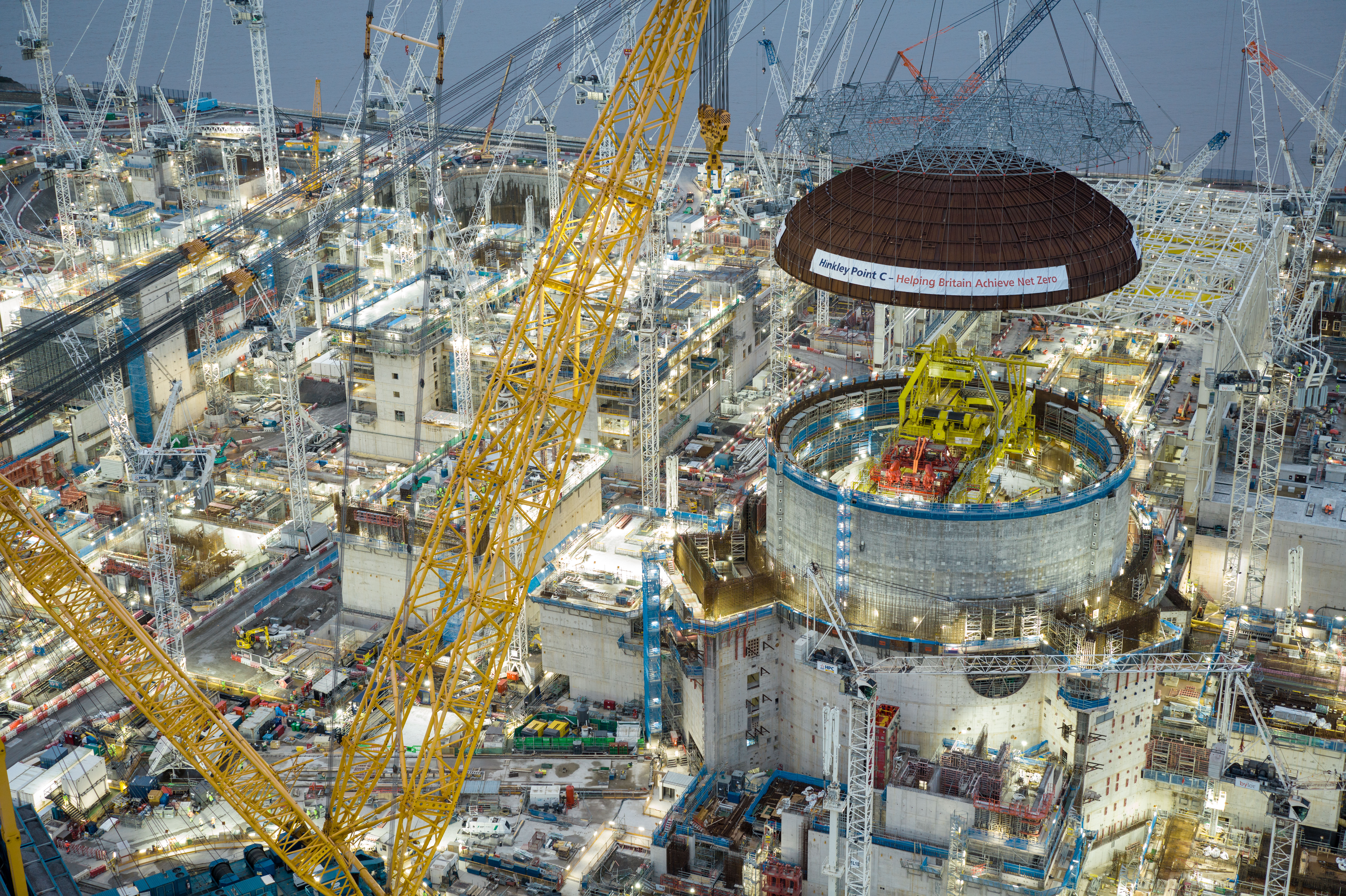 Big Carl has lifted the 245-tonne domed roof onto the first reactor building.