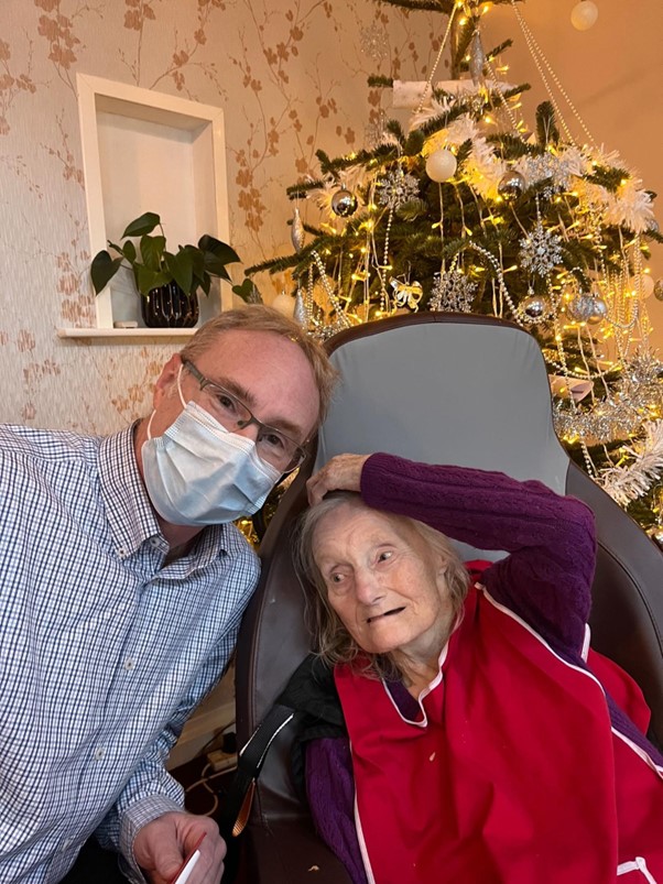 Employee and his mother smiling