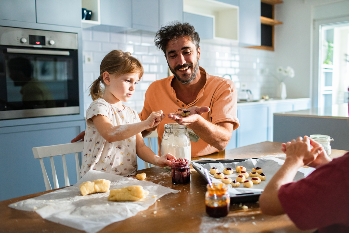 Man and child cooking in a kitchen together