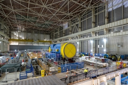 Inside Unit 1’s Turbine Hall. Pictured centre is the 450 tonne Generator Stator. The stator will take the power from the steam produced in the Reactor – via the Steam Turbine – to make electricity. 