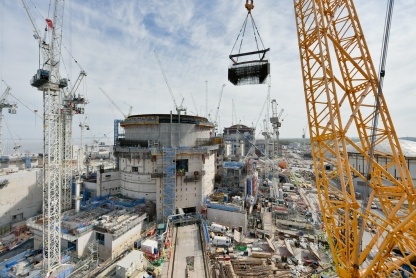 A giant ‘mega-lift’ underway in April. Steel reinforcement for a staircase is being craned into Unit 2 Reactor Building. Steel cages are fabricated and joined together in a satellite yard nearby, speeding up work and removing congestion from the workface. 