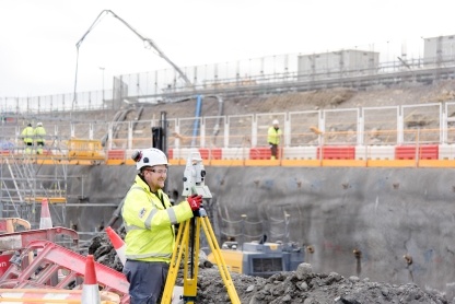 Site engineer scanning rock face concrete spray prior to nailing at the sea wall