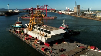 The water in the dock is adjusted several times, to ensure the barge can receive the load securely