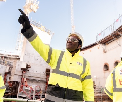 Kwasi Kwarteng MP pointing to the progress at the first nuclear reactor unit.