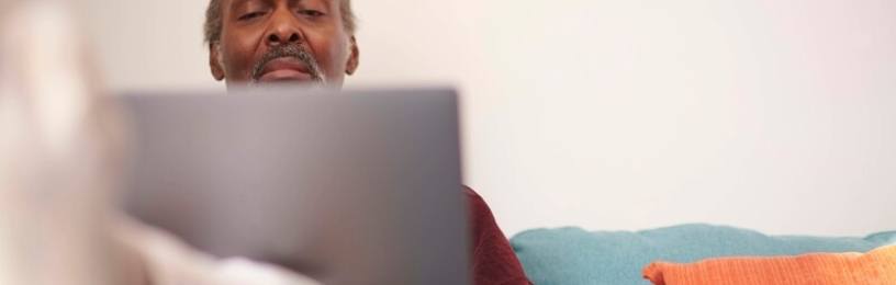 Man on sofa with laptop