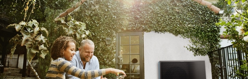 family outside by heat pump
