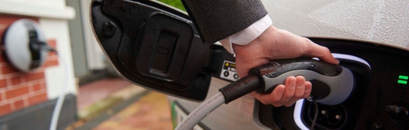 Close up of an EV charger plugged into an EV