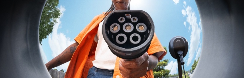 Women plugging in EV charger