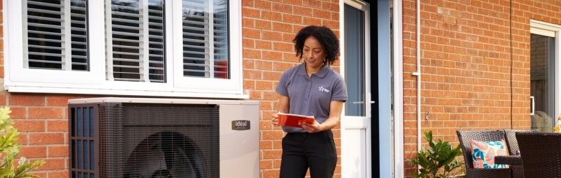 EDF employee standing next to Ideal heat pump