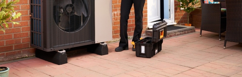 EDF employee standing next to Ideal heat pump