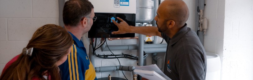 Installer showing customers how to use their air source heat pump system