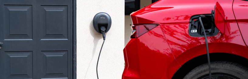 Red electric car plugged into Pod Point charger