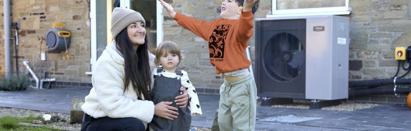 Family in winter clothes playing in the snow 