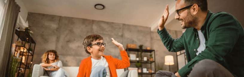 Father and son high fiving 