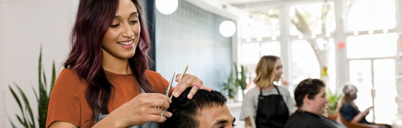 hairdressing salon with customer getting their hair cut, happy and smiling