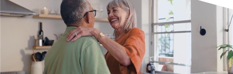 Two people embracing in a kitchen