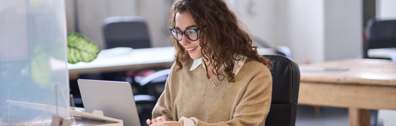 Lady looking at laptop screen in office environment