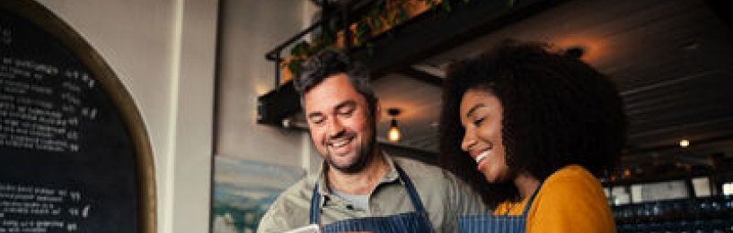 Two small business owners sharing notes