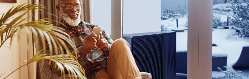 Man looking at his phone inside