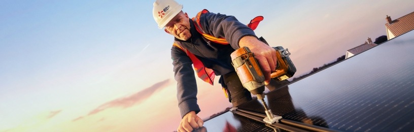 Man on roof installing solar panels