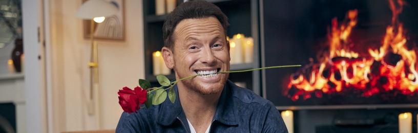 Joe Swash poses with a rose in his mouth