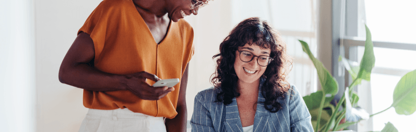 Business owners happy around computer