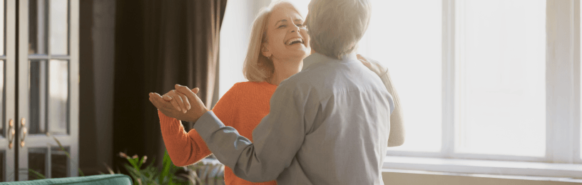 Couple dancing in their living room