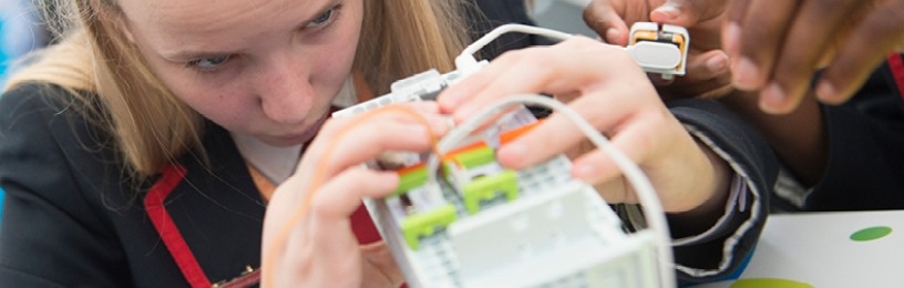 School girl examining computer server