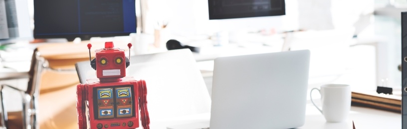 Robot next to a laptop