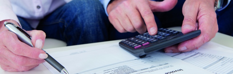 bills and a calculator lie on a table