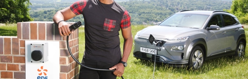 Ore Oduba charging an electric car 