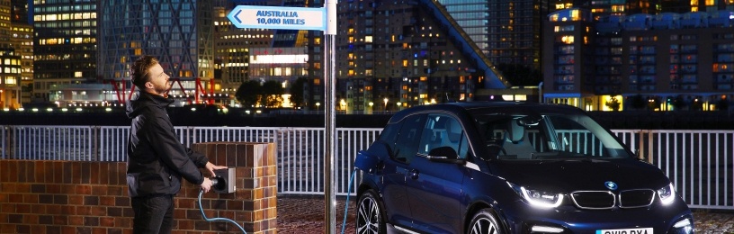 person charging electric vehicle