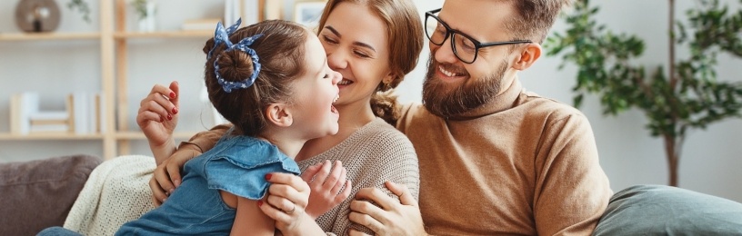 Young family on sofa happy because their boiler is running smoothly