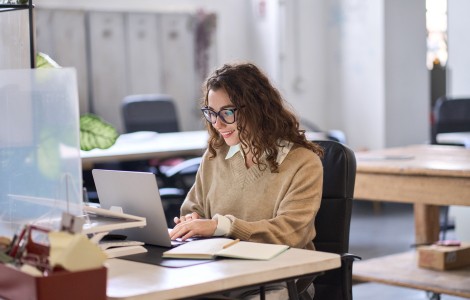 Lady looking at laptop screen in office environment