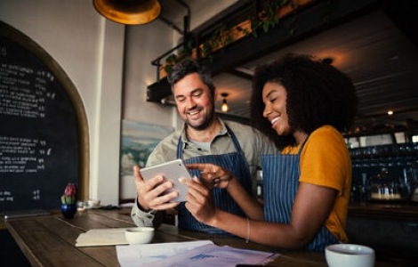 Two small business owners sharing notes