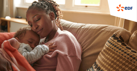 Mother and child cuddle on a sofa