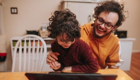 Family looking at laptop.