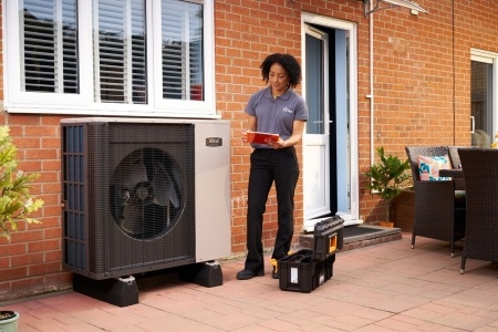 EDF employee standing next to Ideal heat pump