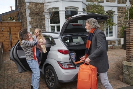 Family unpacking their EV