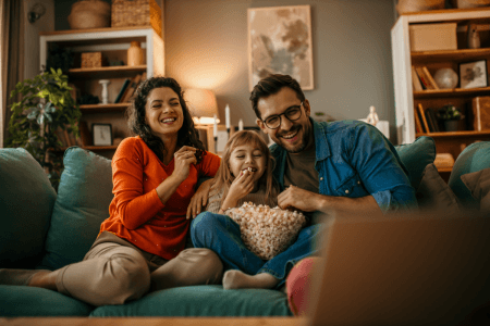 Family sitting on sofa with popcorn
