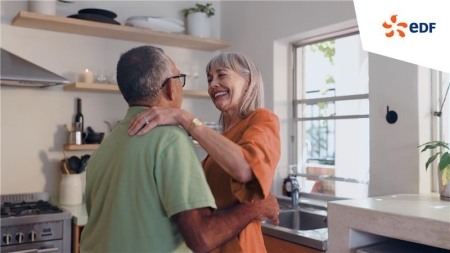 Two people embracing in a kitchen