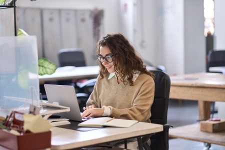 Lady looking at laptop screen in office environment