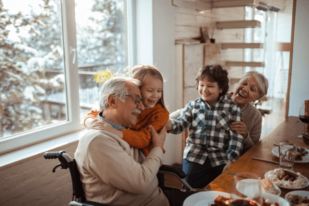 Grandparents sitting with their grandchildren at the dining table