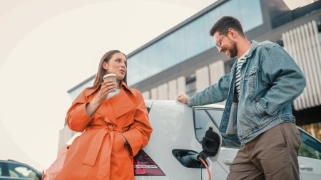 Friends charging EV while talking