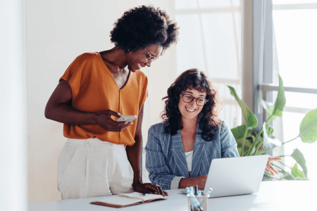 Business owners happy around computer