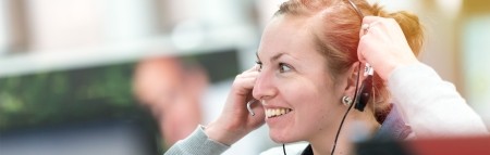 Lady smiling wearing a telephone headset