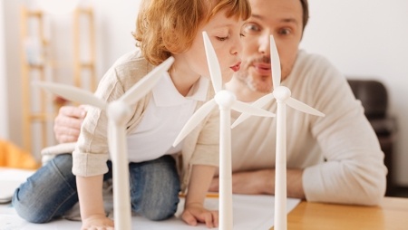 Man and boy looking at a scale model of a wind farm - Alternative energy sources