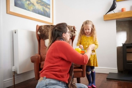 A mother playing with her young daughter